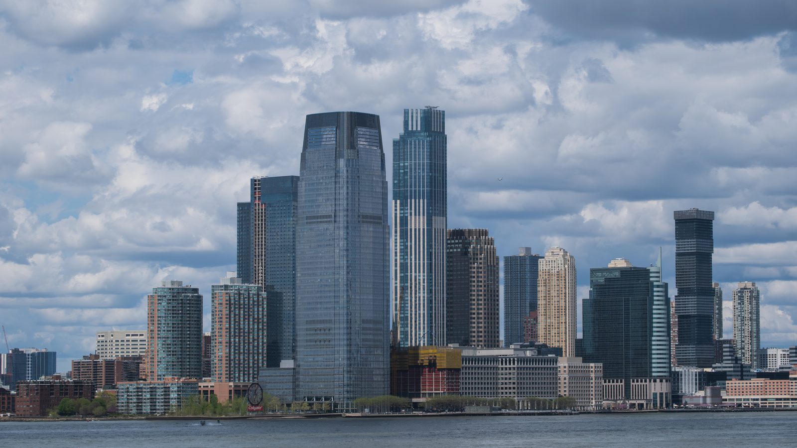 The Jersey City waterfront skyline from the Hudson River, with the Colgate Clock in the foreground and Exchange Place towers behind