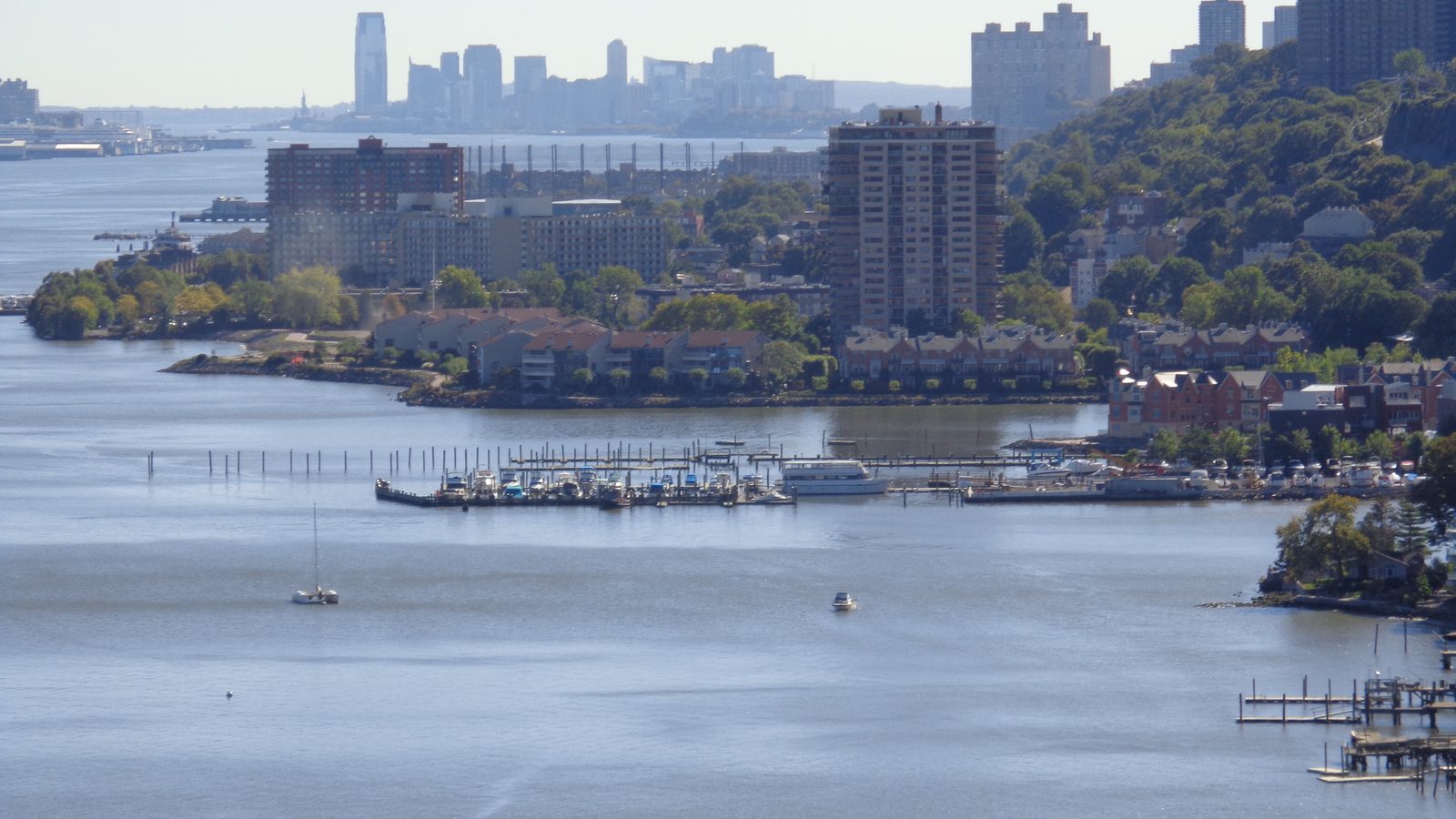 The New Jersey Hudson River waterfront corridor seen from the George Washington Bridge, spanning Fort Lee, Edgewater, and the Jersey City skyline
